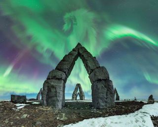 Dragon shaped aurora over arctic henge.